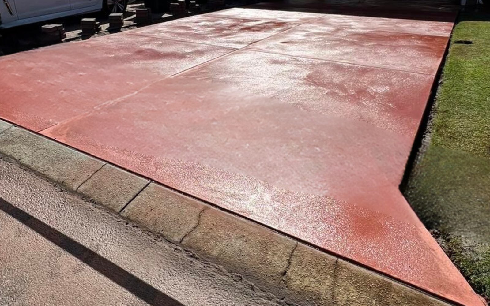 Oxide coloured concrete driveway matched to the house