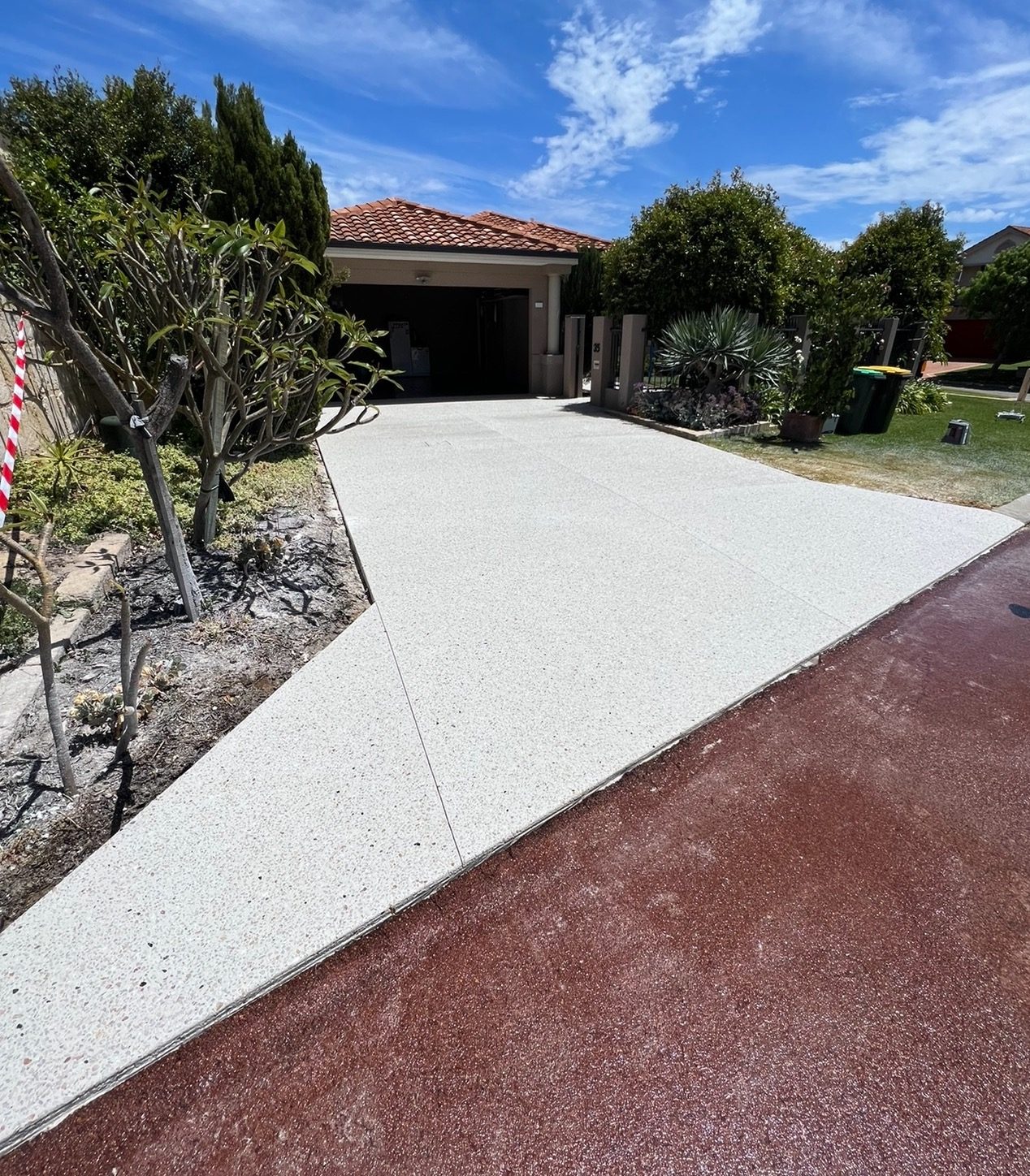 Exposed aggregate driveway poured across the full frontage