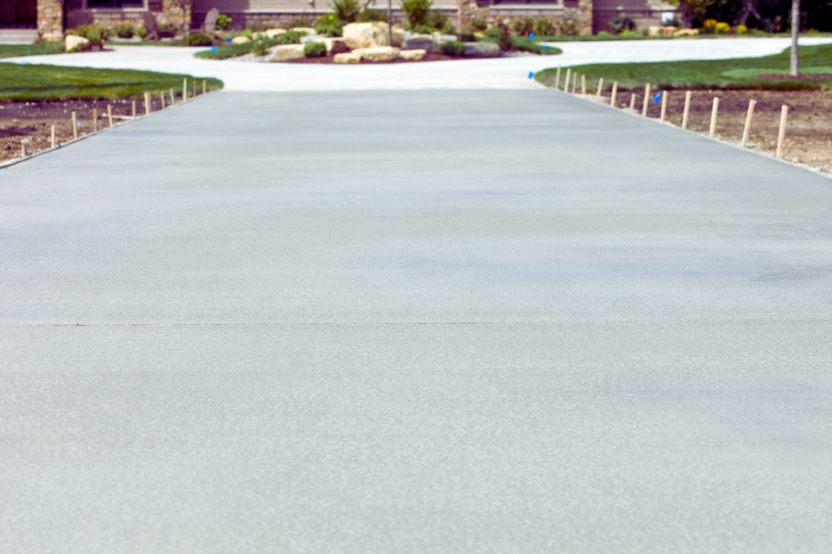 Plain grey concrete driveway with a broom finish